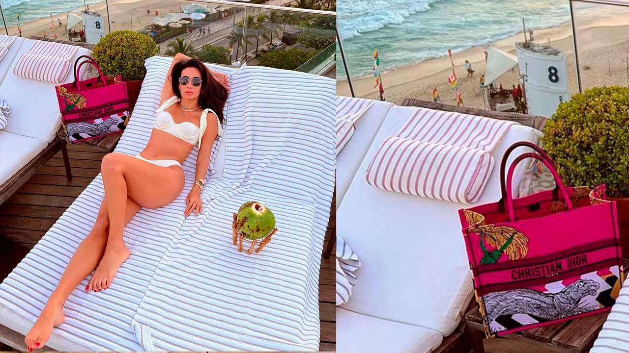 Bolsa Dior Book Tote estampada usada na piscina.