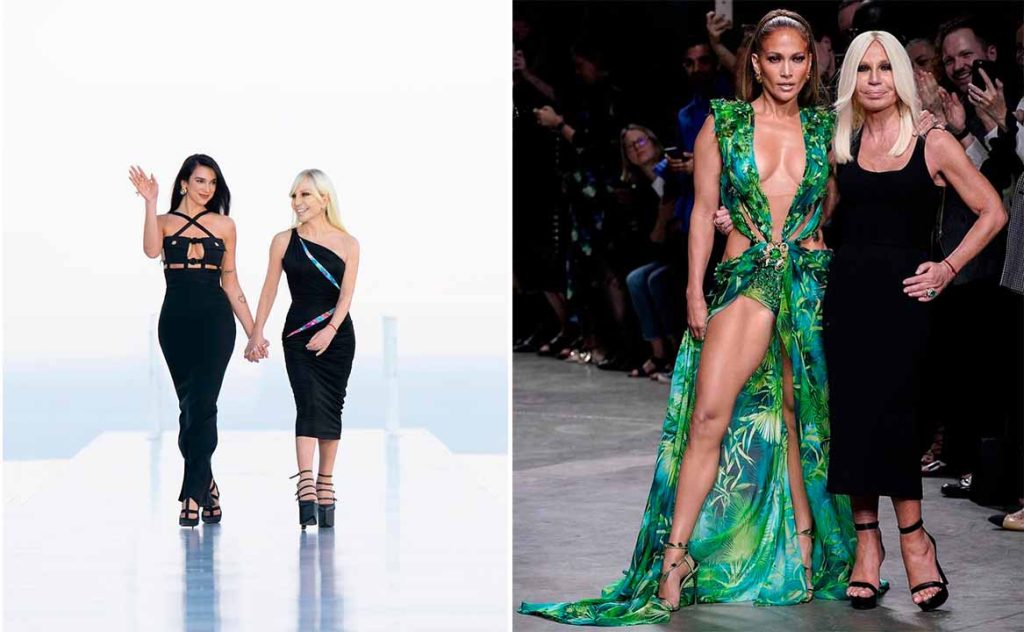 Donatella Versace ao lado das cantoras Dua Lipa e Jennifer Lopez, mostrando a forte ligação da estilista com a cultura pop e o entretenimento
