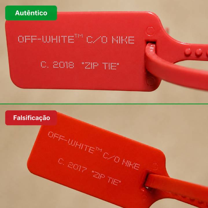 Detalhe do zip tie laranja original do Nike x Off-White com tag de cantos arredondados e símbolo ™ correto — principal elemento de autenticação dos sneakers Off-White